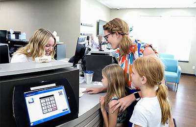 Chiropractic Muskegon MI Front Desk With Patients