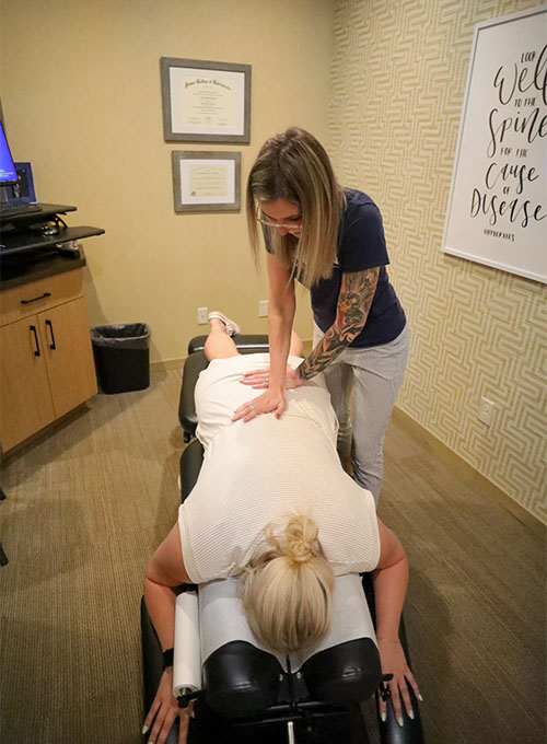 Chiropractor Muskegon MI Alexis Crowell With Patient